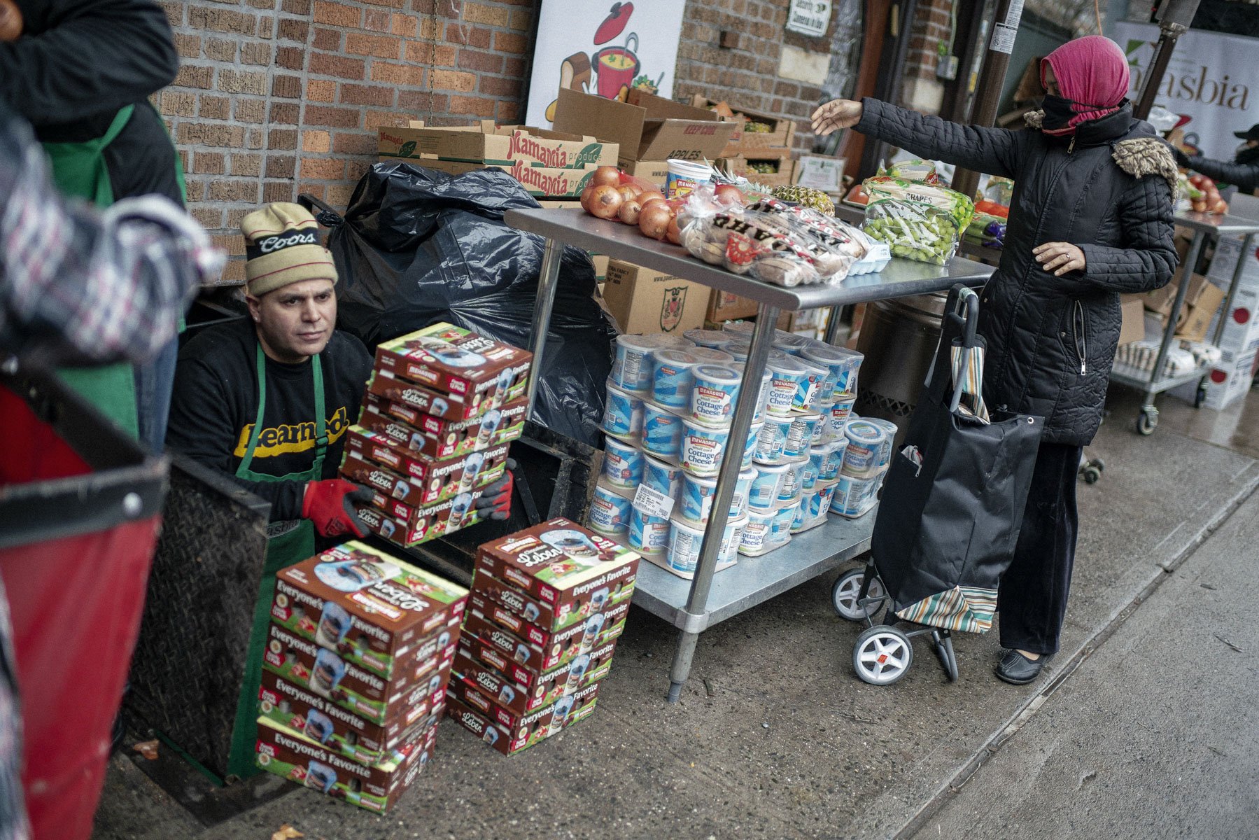 Rafael Morel Jr. loads NY State kosher dairy products to a storage basement at Masbia.