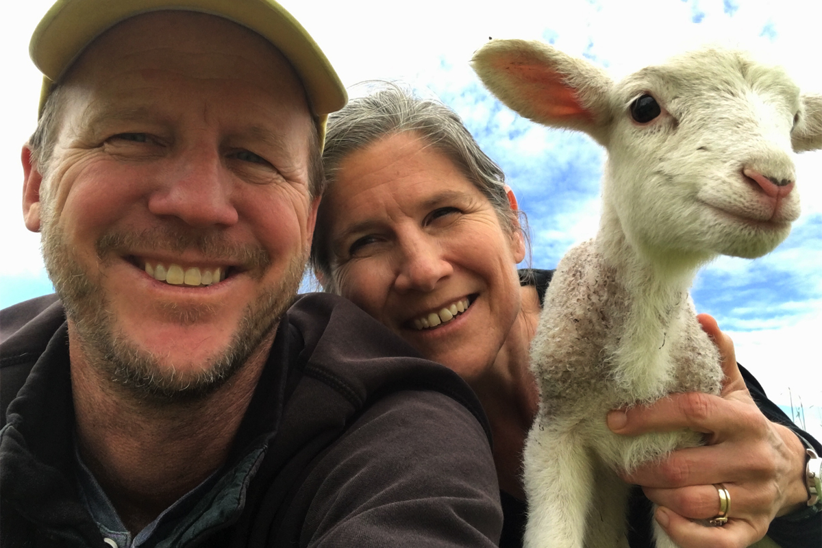 Greg Massa, Raquel Krach, and a newborn lamb.