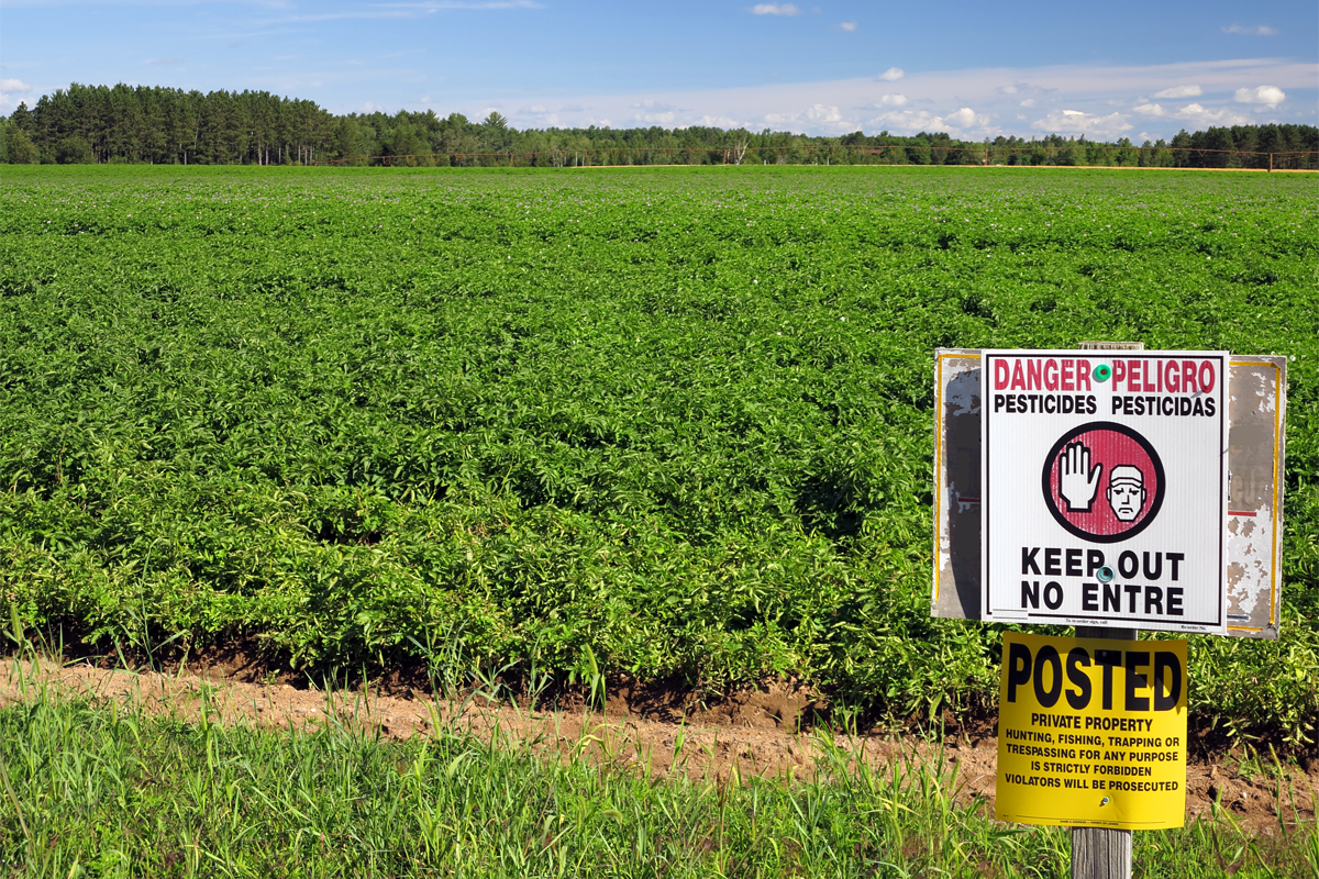 Sign warning about pesticides on a farm