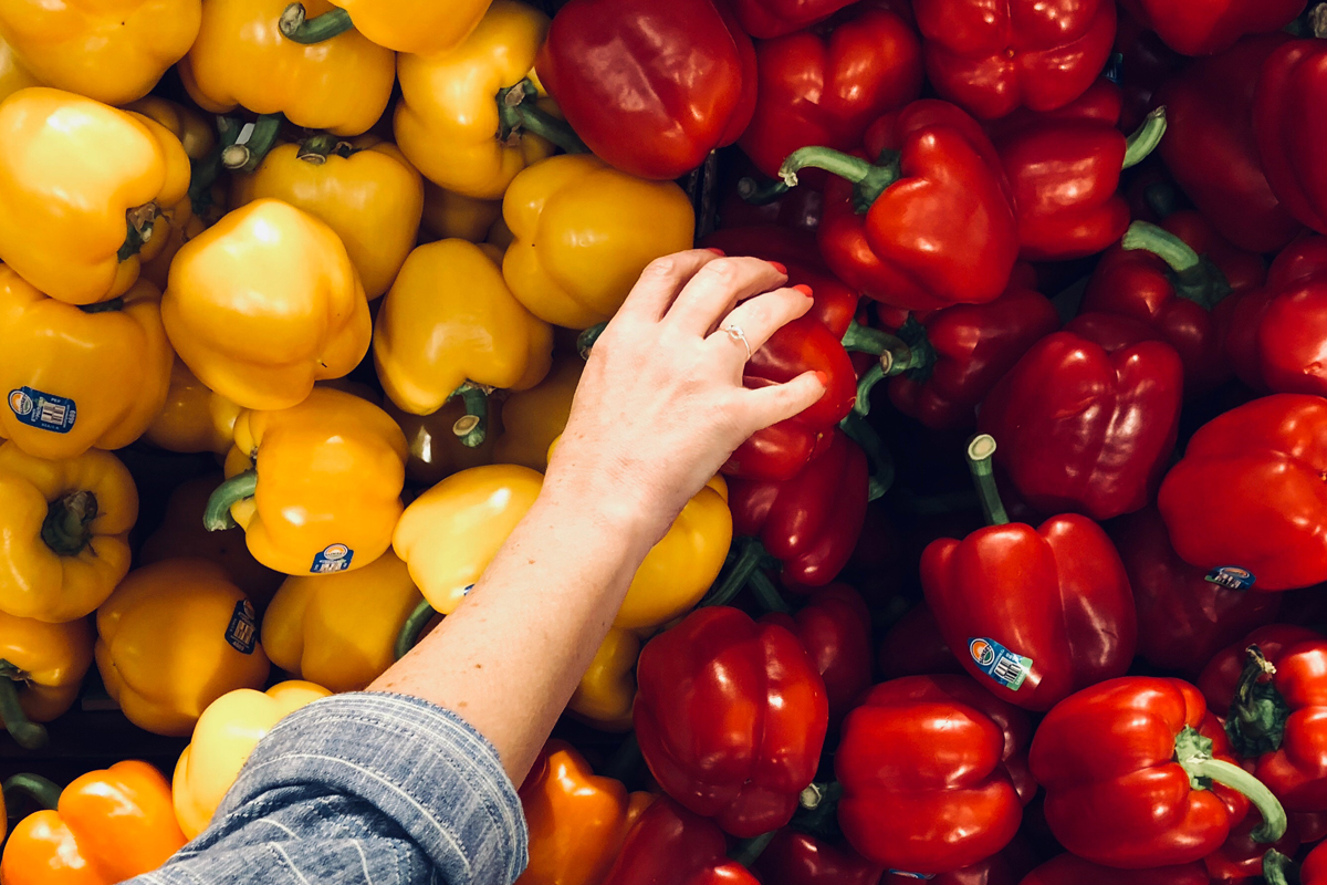 hand reaching for organic produce at the supermarket