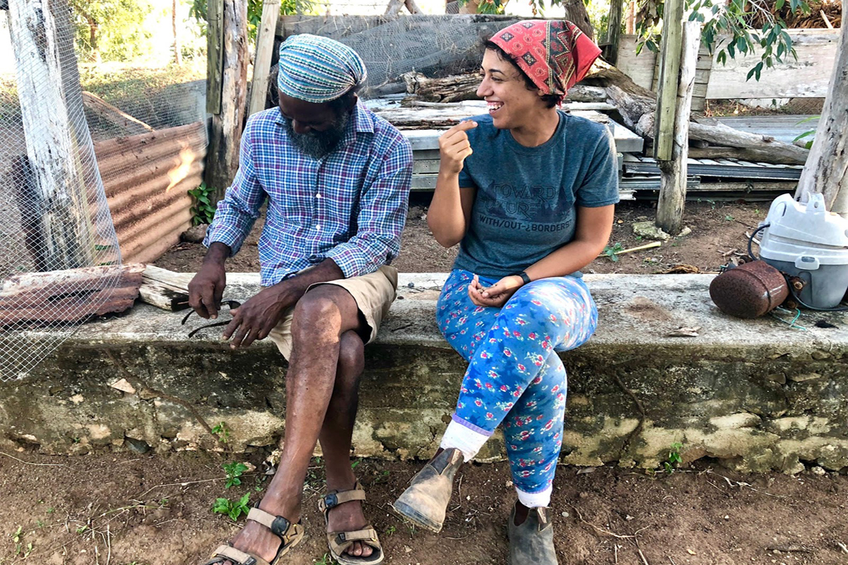 Jorge and Ana sit on the remains of one of their structures destroyed after Hurricane Maria in 2017. (Photo © Sarah Sax)