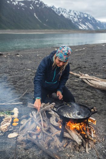 Salmon sister cooking on the rocky beach of Alaska.