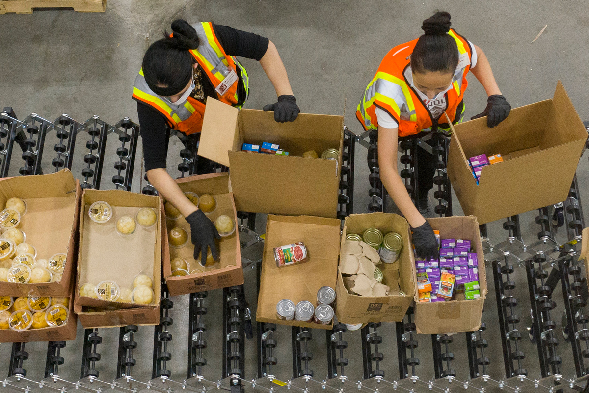 Filling a USDA harvest box. (USDA photo by Lance Cheung)