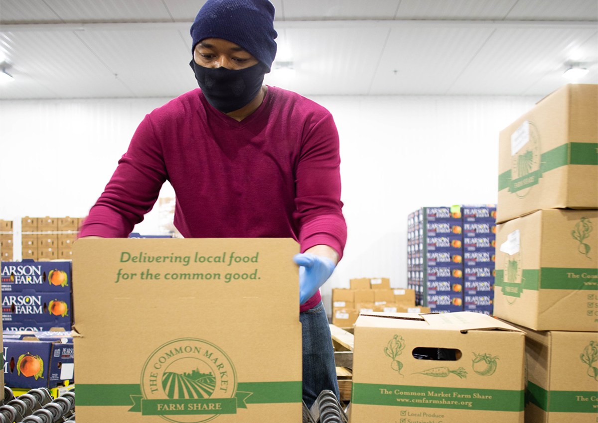 Stacking pallets of USDA Farm Boxes at the Common Market warehouse in Georgia. (Photo by Emma Rolader for The Common Market)