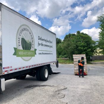 Delivering a stack of USDA Farm Boxes from The Common Market. (Photo by Lisa Held)