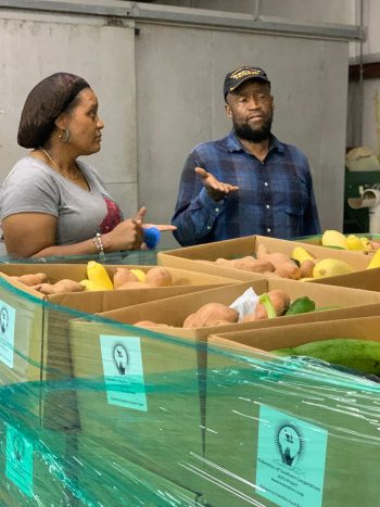 Darnella Burkett Winston talks with a co-op manager. (Photo courtesy of the Federation of Southern Co-ops)