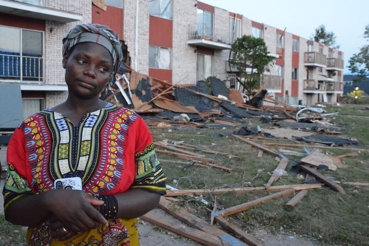 A woman stands outside the Cedar Terrace apartments after the derecho destroyed the building. Photo by Pat Rynard for Iowa Starting Line.