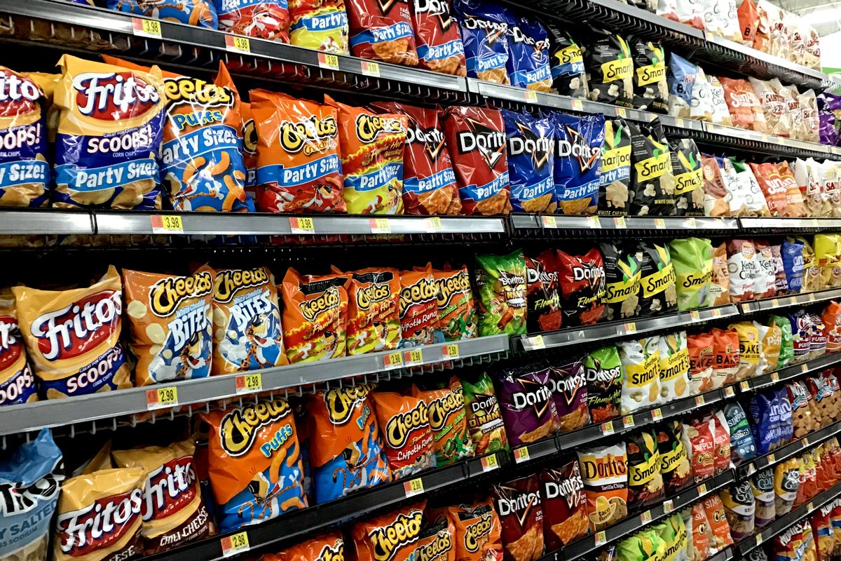 Dozens of kinds of potato chips, corn chips, and other ultra-processed foods in the supermarket. (Photo credit: Mike Mozart)