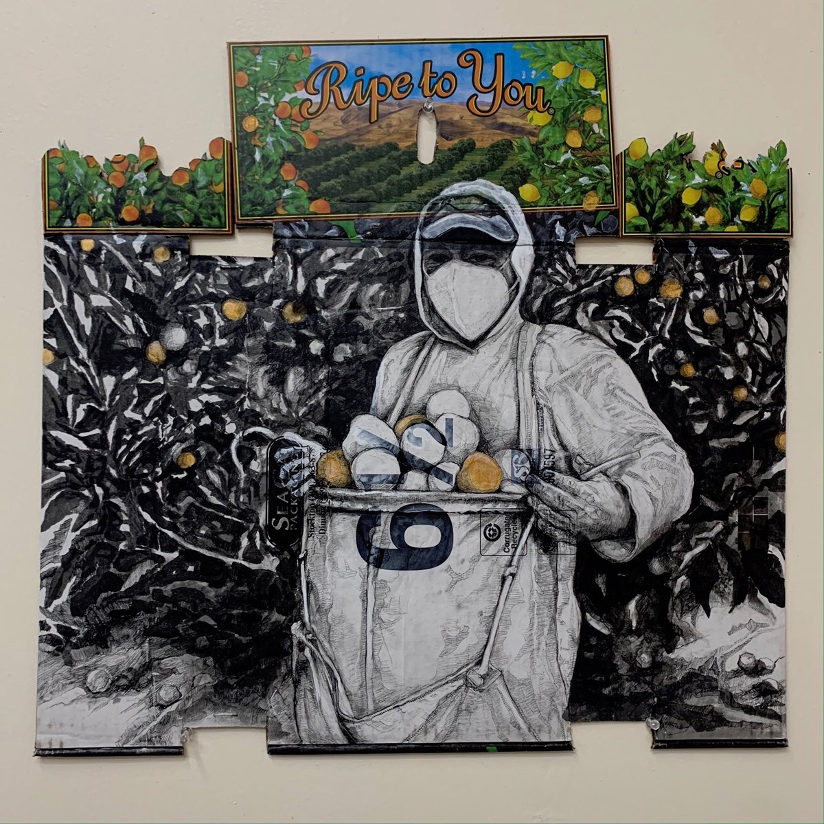 Narsiso Martinez's work, "Ripe to You, 2020." Ink, Gouache, Charcoal, Acrylic, and Matte Gel on Cardboard from a Produce Box. (Photo courtesy of the artist)