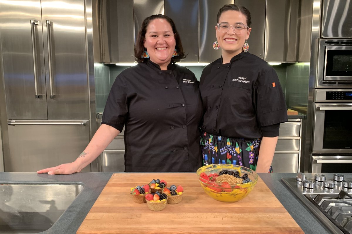 Elena Terry, (left) and Zoe Fess smile after showcasing Seedy SassSquash, a signature family dish, during the Smithsonian’s 